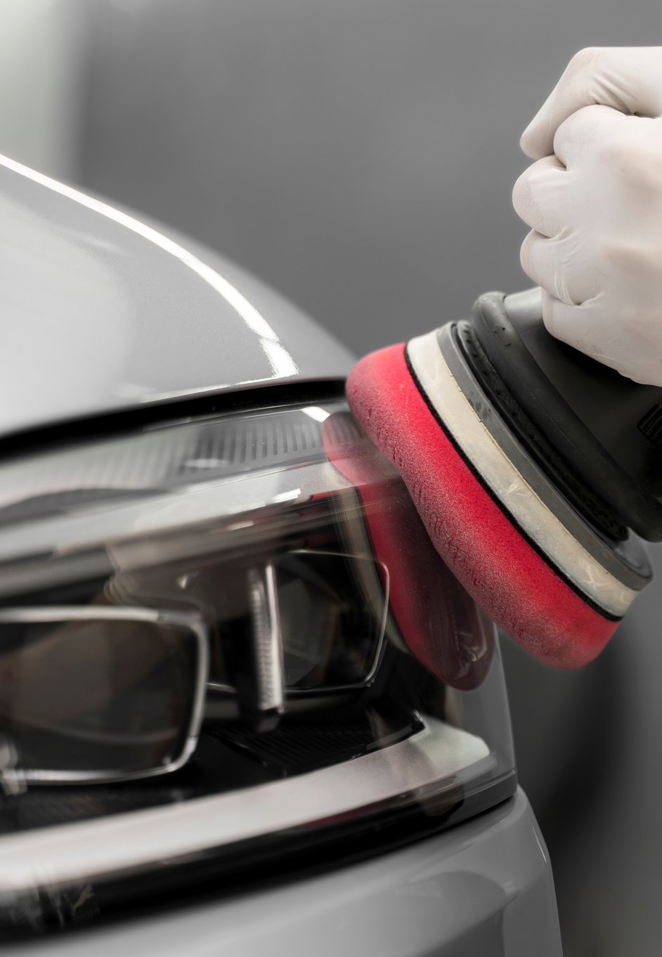a car headlight being polished
