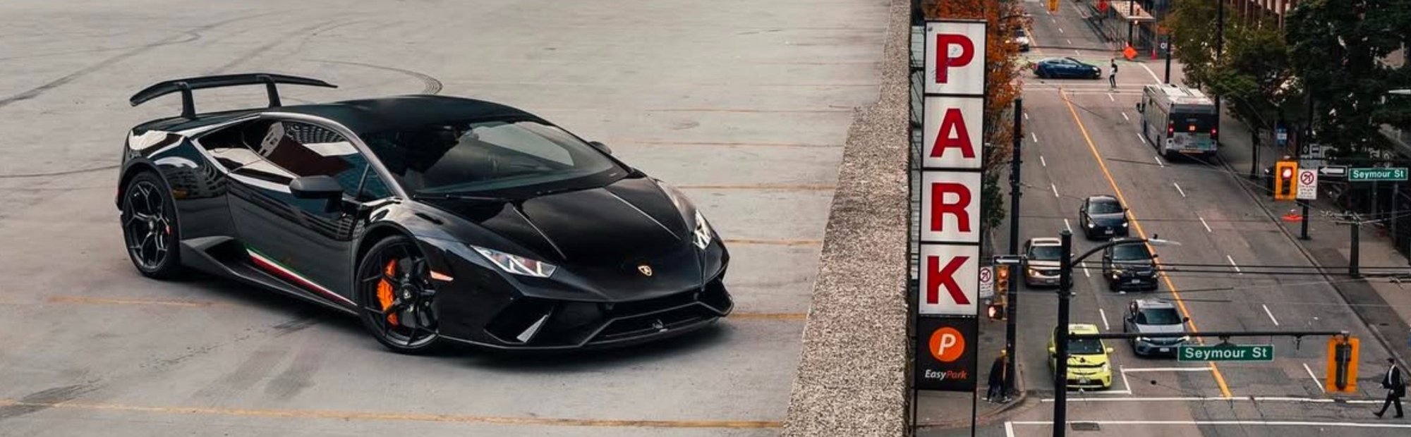 a high-end sports car on the top of a multi-storey car park