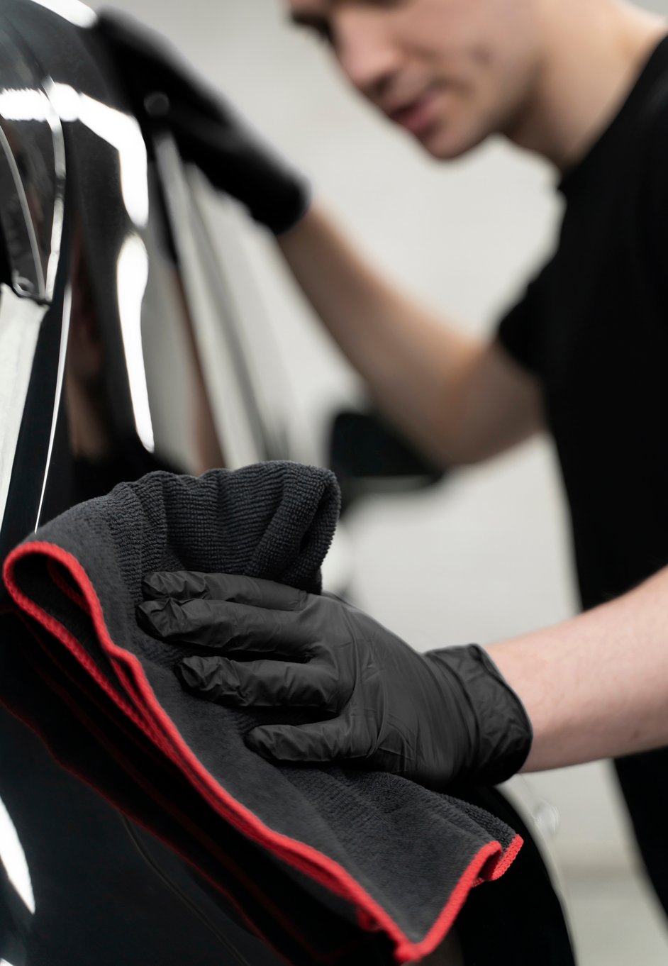 a mechanic applying a paint protection film to a car
